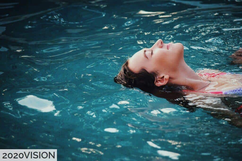 woman floating on body of water