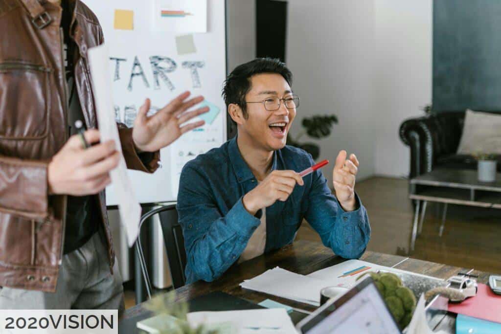 Engaged team members in a lively office meeting discussing startup ideas and innovation.
