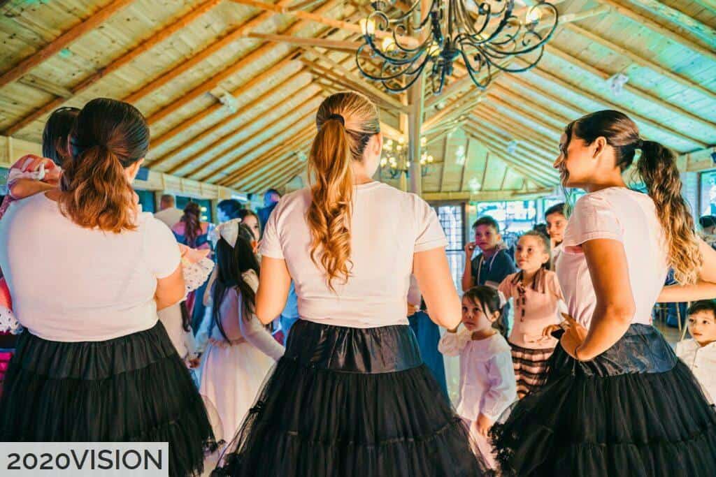 People dancing at a lively indoor gathering
