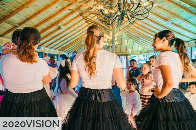 People dancing at a lively indoor gathering