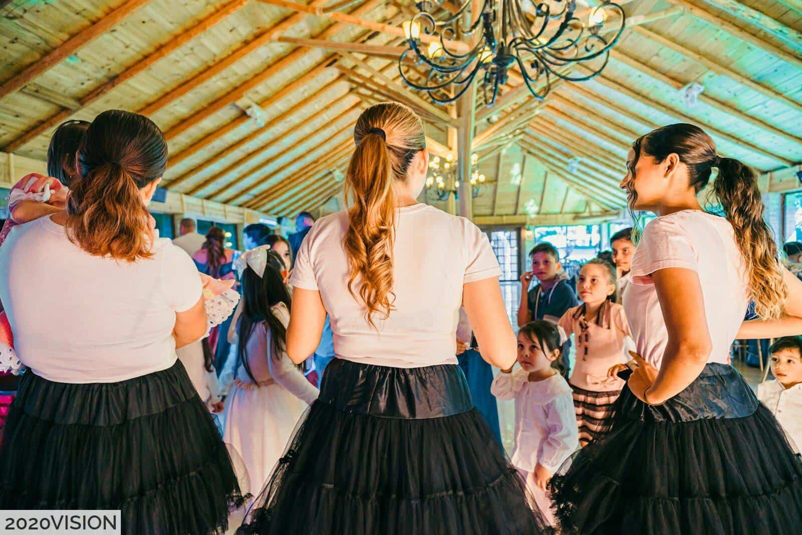 People dancing at a lively indoor gathering